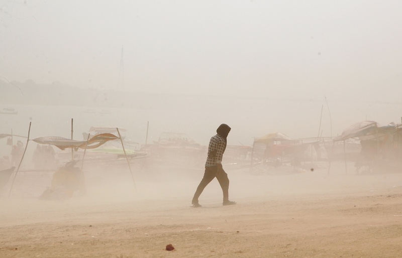 Indians brave  the heat wave at the bank of Sangam, the confluence of Holy river Ganges , Yamuna and mythical Saraswati during the hot summer day in Prayagraj, India.